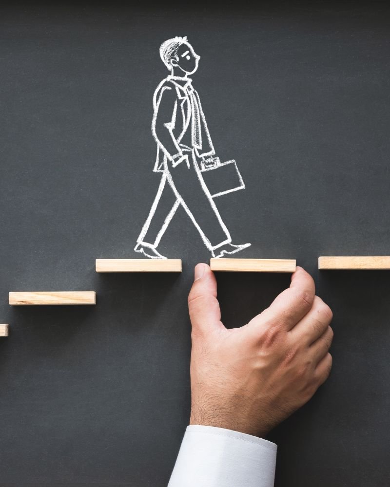 a hand drawing a man walking on a step of wooden blocks