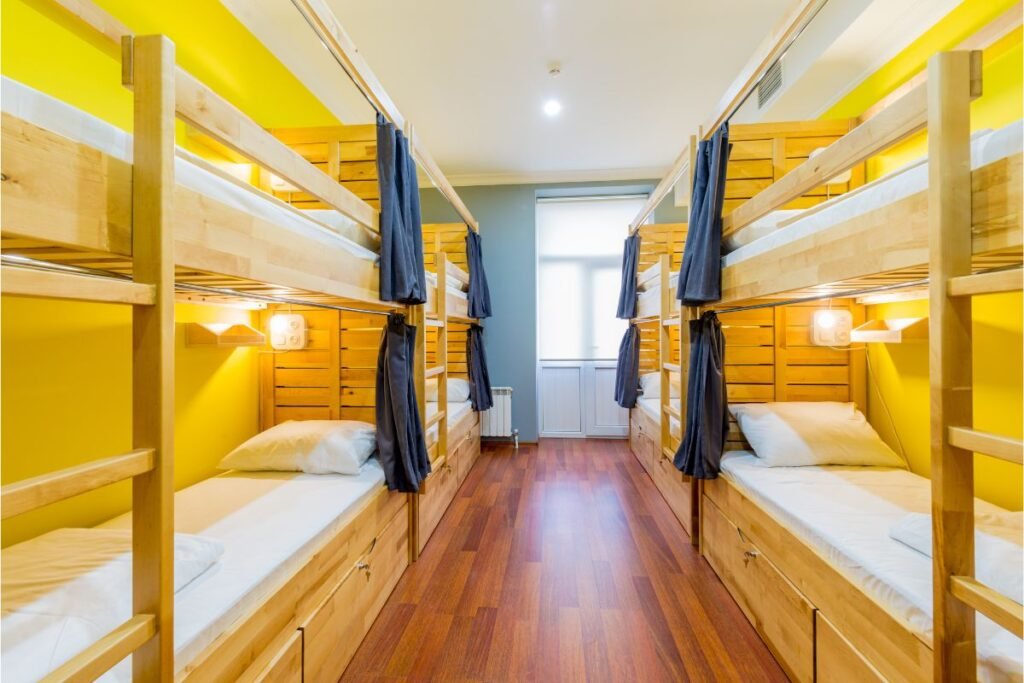 a room with bunk beds and wooden floor